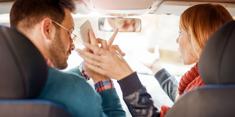 Driver on His Phone Arguing with a Passenger and Not Paying Attention to the Road