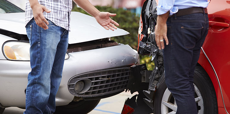 Two People Talking Next to Cars that Collided