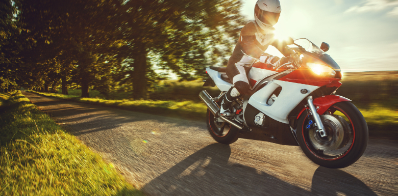 Man Practicing Motorcycle Safety Tips as He Rides During the Fall